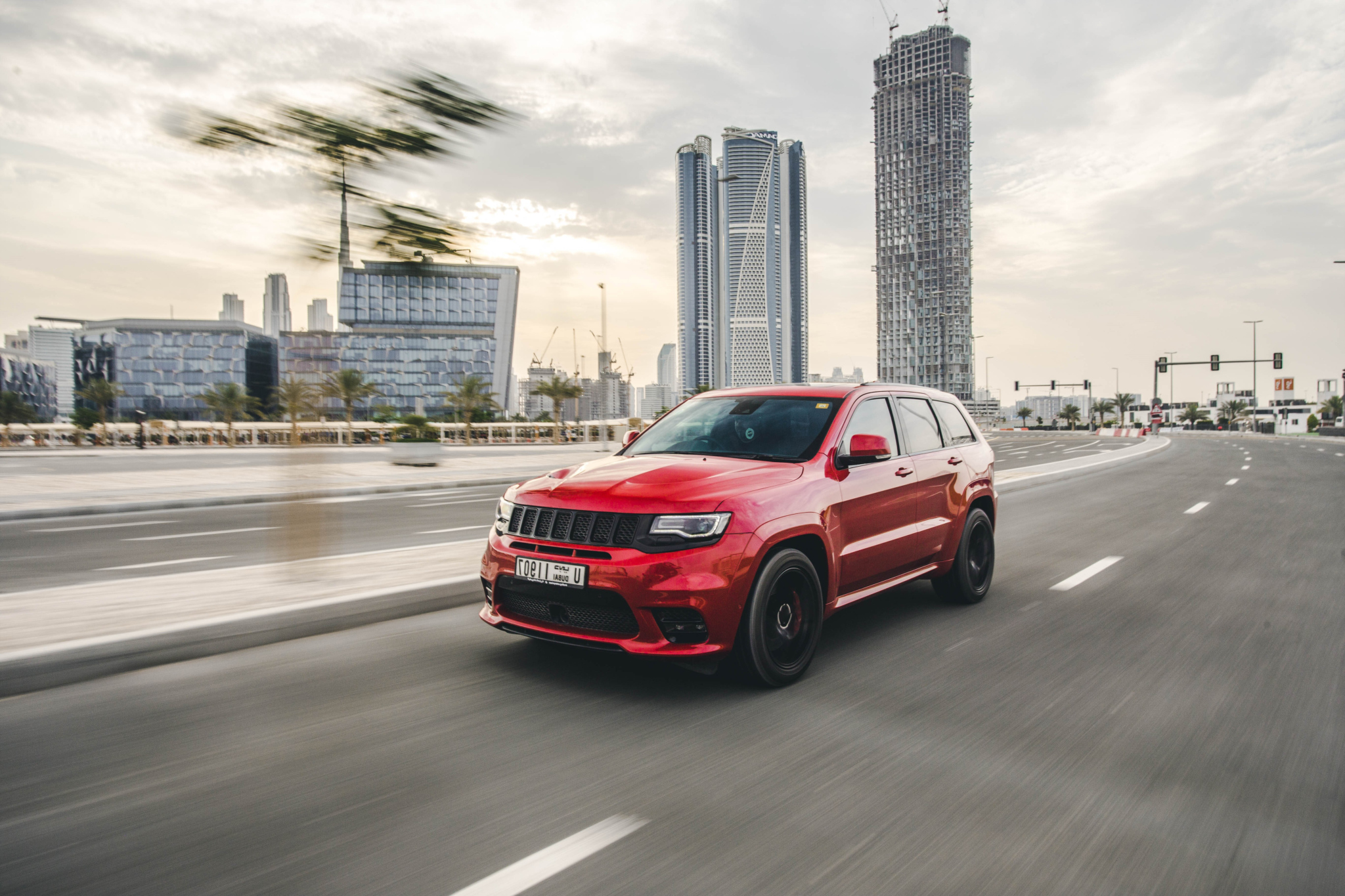 Red sport car extreme motion through megapolis buildings