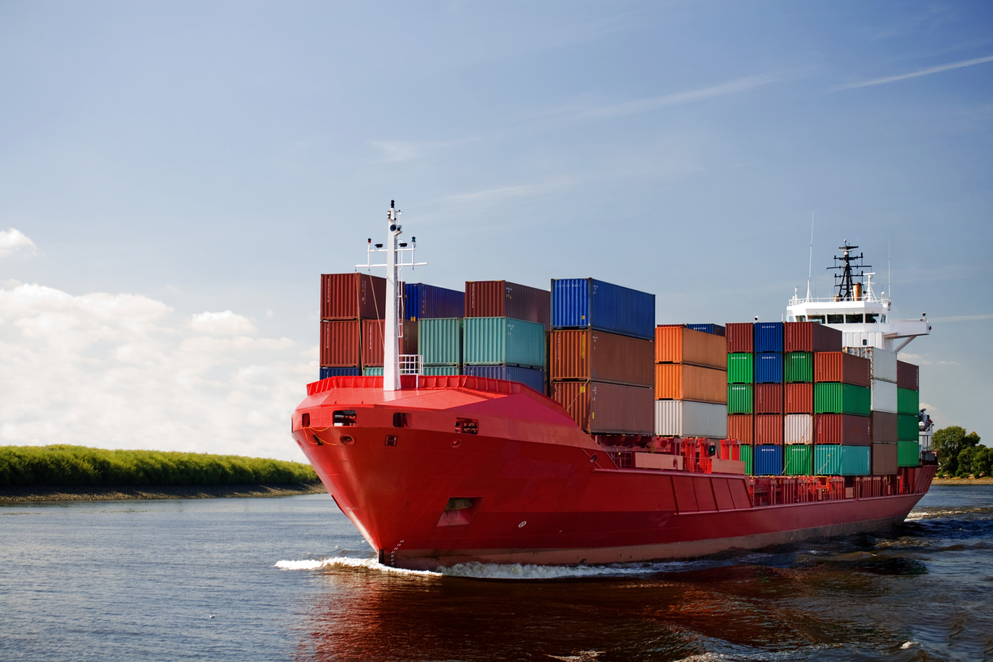 cargo container ship - freighter navigating river