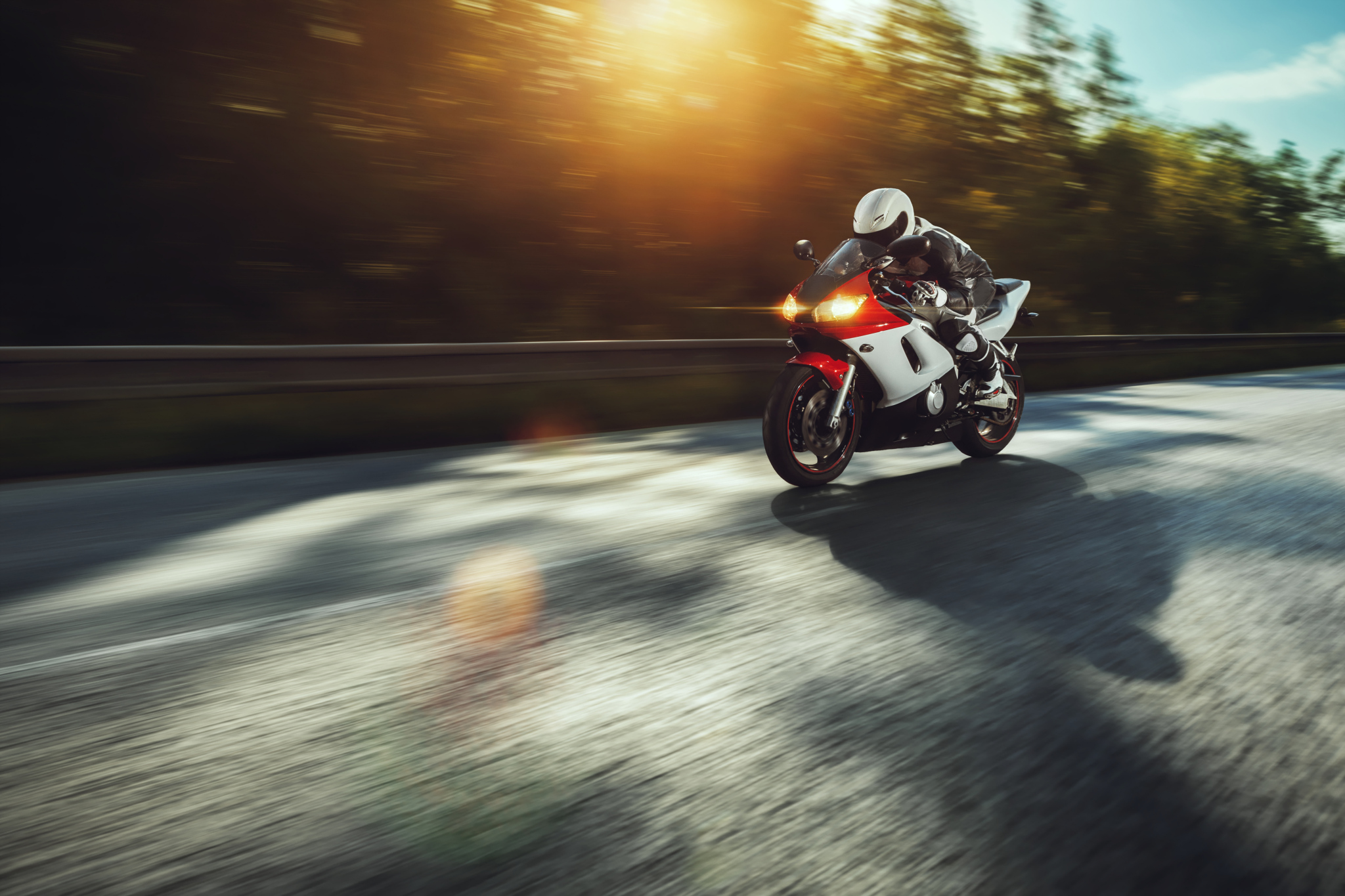 man riding motorcycle in asphalt road